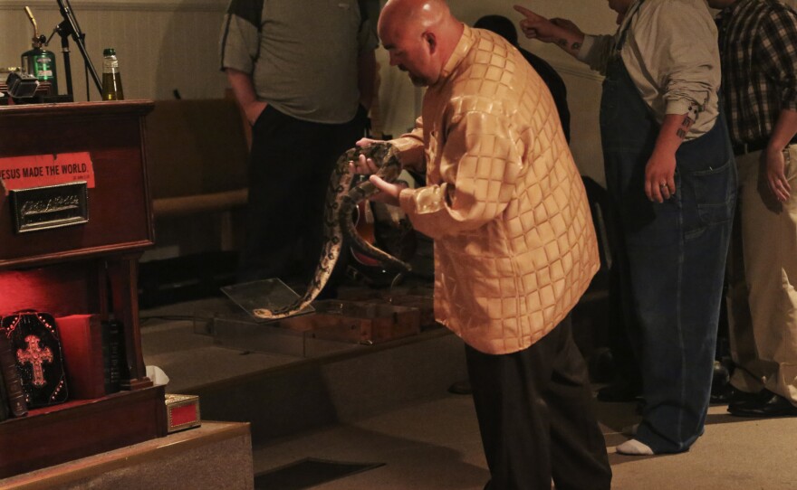 Pastor Jamie Coots holds a snake at Full Gospel Tabernacle in Jesus Name Church of Middlesboro, Ky.