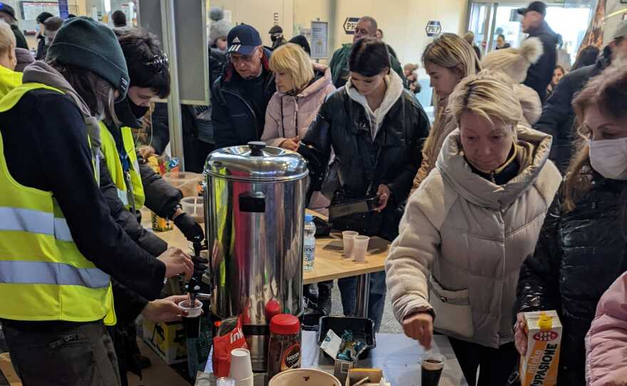 Ukrainian refugees receive help and services at the main train station in Warsaw, Poland.