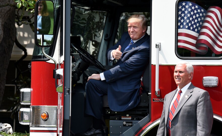 President Trump sits inside a firetruck from a Wisconsin-based manufacturer for a "Made in America" event on the South Lawn of the White House on Monday. Later in the day, enough Senate Republicans voiced opposition to their party's health bill that it could not move forward.