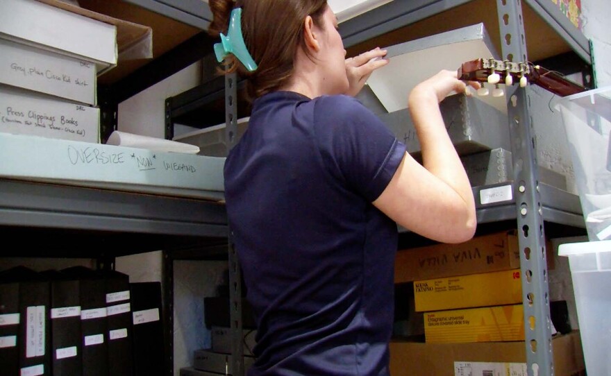 Archivist Emily Brolaski digging through a box inside the archive at the Leo Carrillo Ranch Historic Park in Carlsbad, Calif., Dec. 11, 2024.