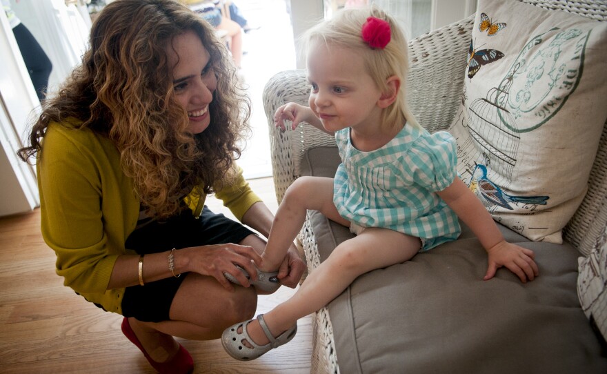 Morales places a shoe back on Kelly's 1-year-old niece Grace Gipson. Morales, who struggles with multiple sclerosis, says her years with Costello have been "the happiest years of my life."