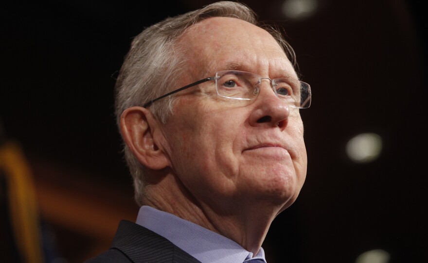 Senate Majority Leader Harry Reid of Nevada listens to a reporter's question about a meeting with Senate Republicans.