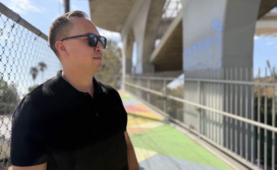 Caltrans' Nick Buenviaje stands at the base of a pedestrian bridge in San Ysidro on July 17, 2026. "There's a lot of history along this bridge," he said.
