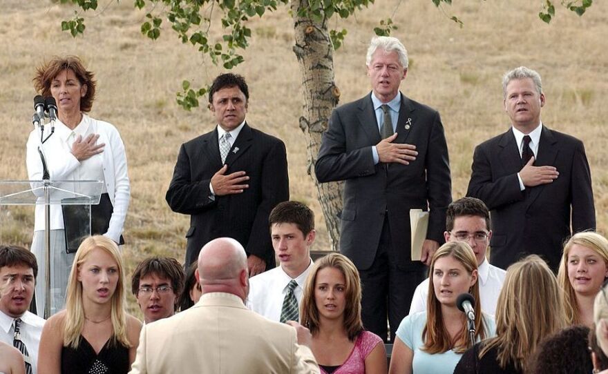 Columbine High School principal Frank DeAngelis sings in 2006 alongside former president Bill Clinton at a groundbreaking ceremony for a memorial near the school.