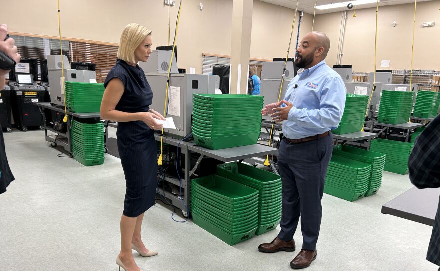 Margaret Hoover and Broward County Supervisor Joe Scott (D) discuss election administration at the Equipment Center in Lauderhill, Florida.