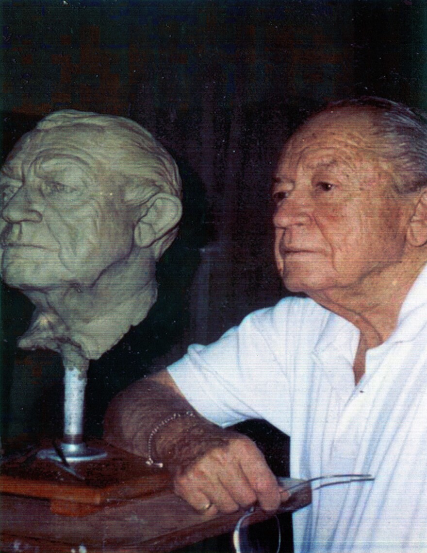 Sen. William Anderson Craven poses next to his bust in 1992.
