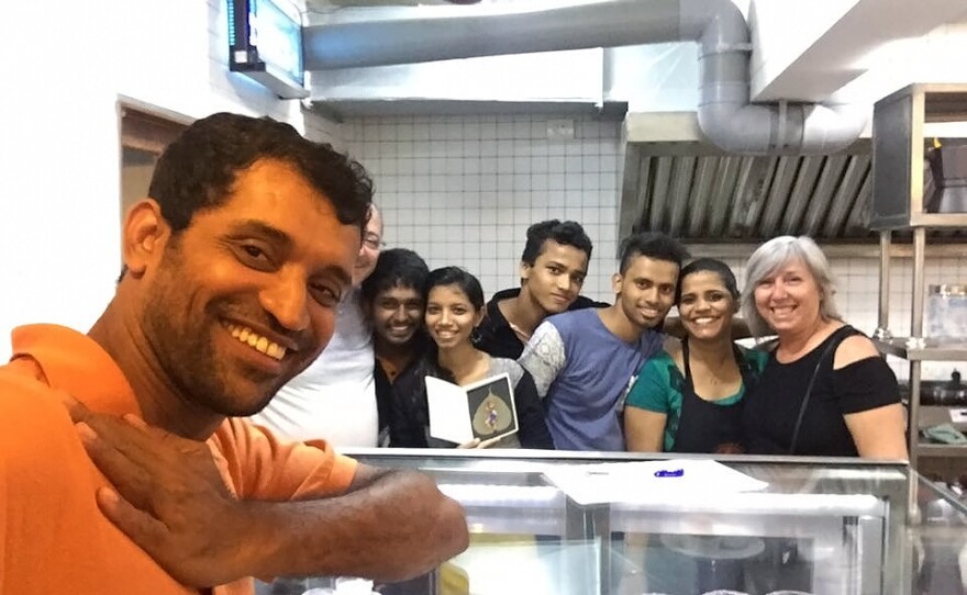 Amin Sheikh, the owner of Bombay to Barcelona Library Cafe along with his employees.