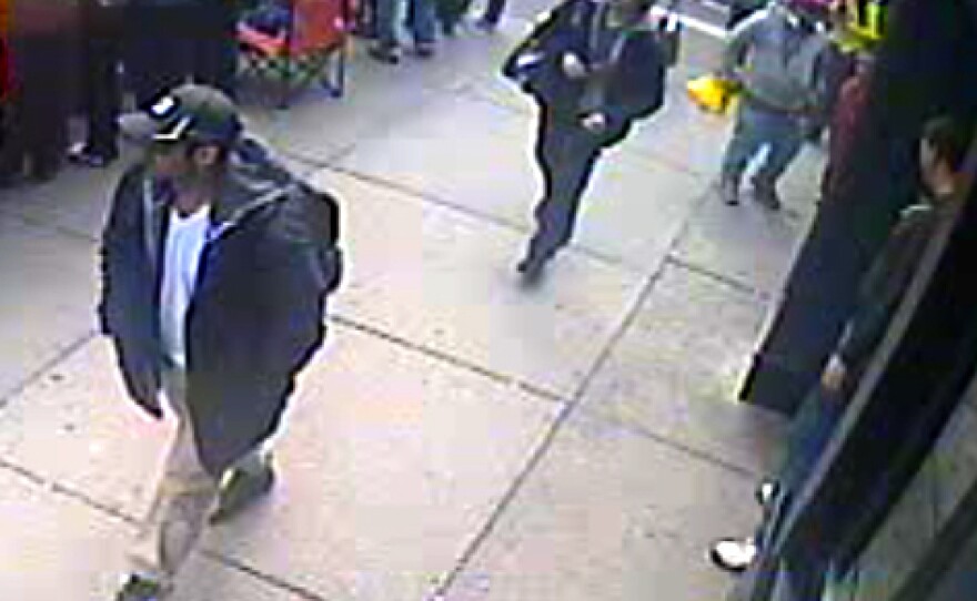 This image from a surveillance video, taken near the finish line of the Boston Marathon, helped investigators identify Tamerlan Tsarnaev (in black cap) and his brother, Dzhokhar (in white cap), as the main suspects in the bombings.