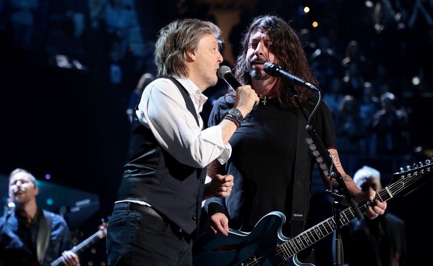 Paul McCartney performs with Dave Grohl during the Foo Fighters' induction into the Rock & Roll Hall Of Fame on October 30, 2021 in Cleveland, Ohio.