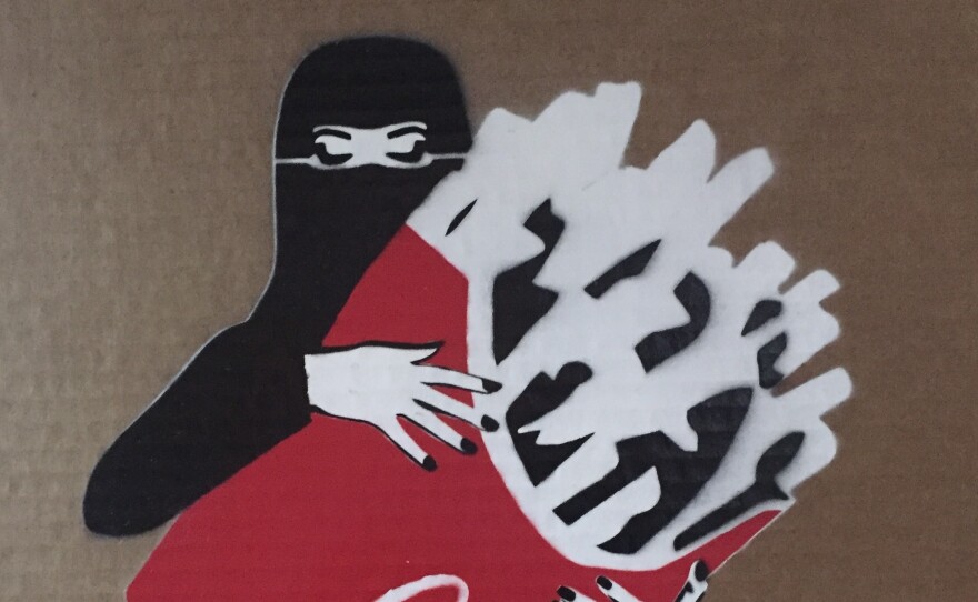 A velied woman with fries, from the "LoudArt" exhibit in Jeddah, Saudi Arabia.