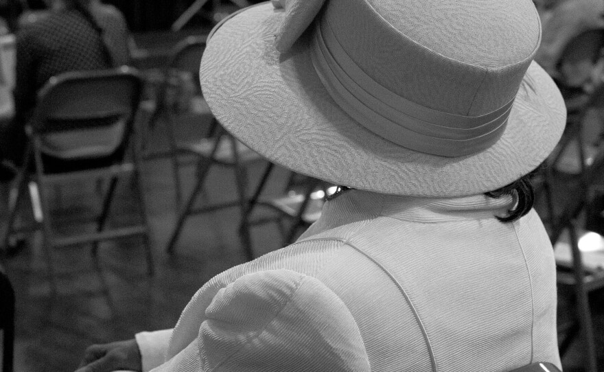 A woman listens to a speaker at the People's Justice and Peace Conference at the Ohio City Masonic Arts Center.