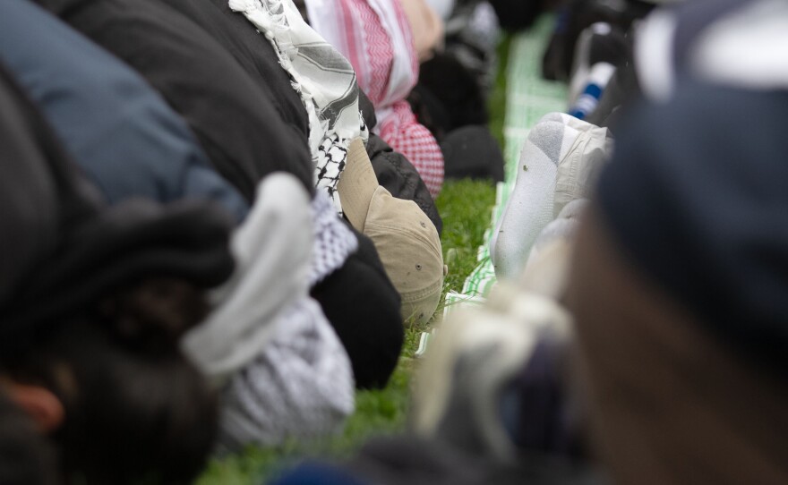 People sit in prayer at a protest for Gaza at UCSD in San Diego, Calif. March 6, 2024.