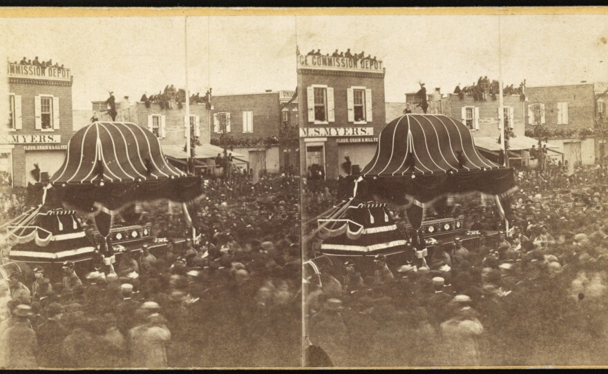 A crowd surrounds President Abraham Lincoln's funeral procession in Philadelphia in 1865. After his assassination in Washington, Lincoln's body was taken on a 1,700-mile train trip that stopped in major cities on its way to his home in Springfield, Ill. This stereo image, with two almost identical views, could be seen with a stereoscope to create the perception of a 3-D image.