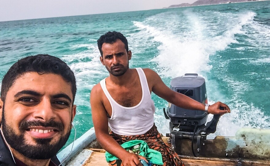 A "getaway selfie," as Mokhtar Alkhanshali calls it: Alkhanshali (left) makes his way across the Red Sea with this boat driver — and without navigation equipment.