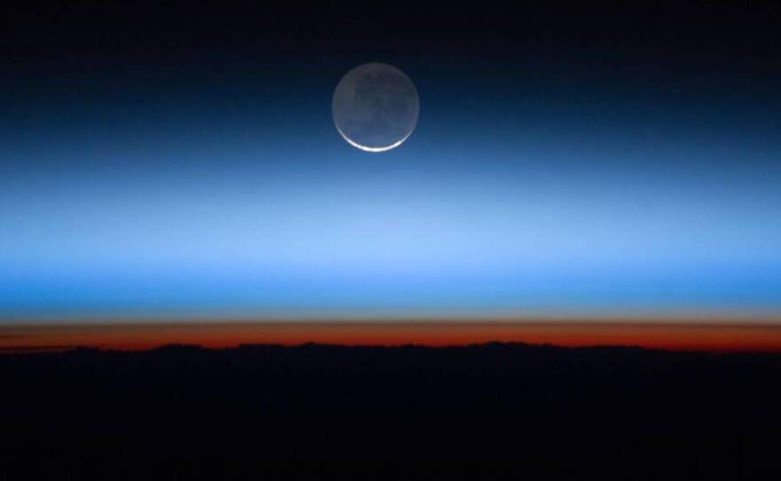 Earth's atmosphere photographed from the International Space Station. Greenhouse gases have accumulated rapidly and are trapping extra heat in the atmosphere. It will take decades for the gases to break down naturally or be reabsorbed on Earth's surface.