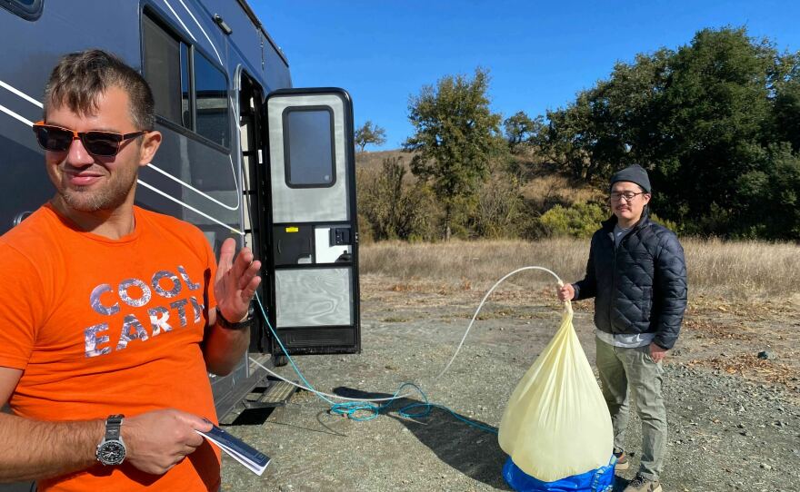 Iseman and Song prepare a balloon with sulfur dioxide and helium.