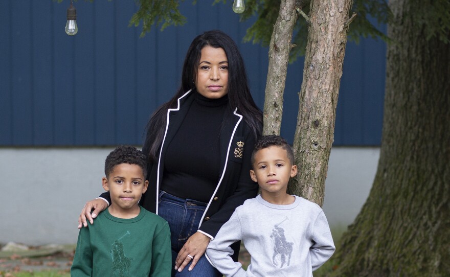 Farida Mercedes and her two sons Sebastian, 5, (left) and Lucas, 7, stand in their backyard in Fairlawn, N.J. Mercedes left her job as an assistant VP of HR at L'Oreal in August after working there for 17 years. As hundreds of thousands of women dropped out of the workforce in September, Latinas led the way, leaving at nearly three times the rate of white women.