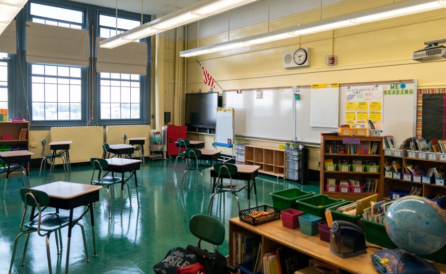 New York public schools are offering two main options to students and their families: "blended" learning, which includes time at schools and remote instruction; or 100% remote learning. Here, students' desks in a public elementary school in Brooklyn are spaced apart for social distancing.