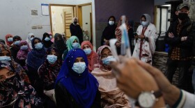 Dr. Kishwar Tanwir holds up syringes as she shows female health workers in Karachi how to inject the Pfizer COVID-19 vaccine. Pakistan has dispatched some 13,000 teams of female-led vaccinators to bring up the country's vaccination rate. Female health workers are more likely to get access to women in conservative households who don't speak to men.