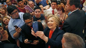 Democratic presidential candidate Hillary Clinton takes a selfie with supporters at a rally in El Centro, June 2, 2016.