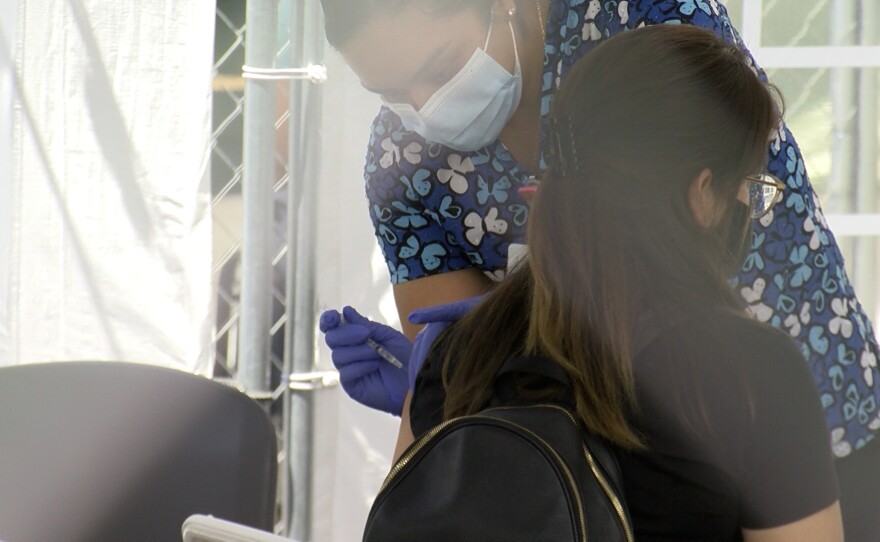 Janet Jurado receives a COVID-19 vaccine at the Family Health Center in Logan Heights on August 26, 2021.