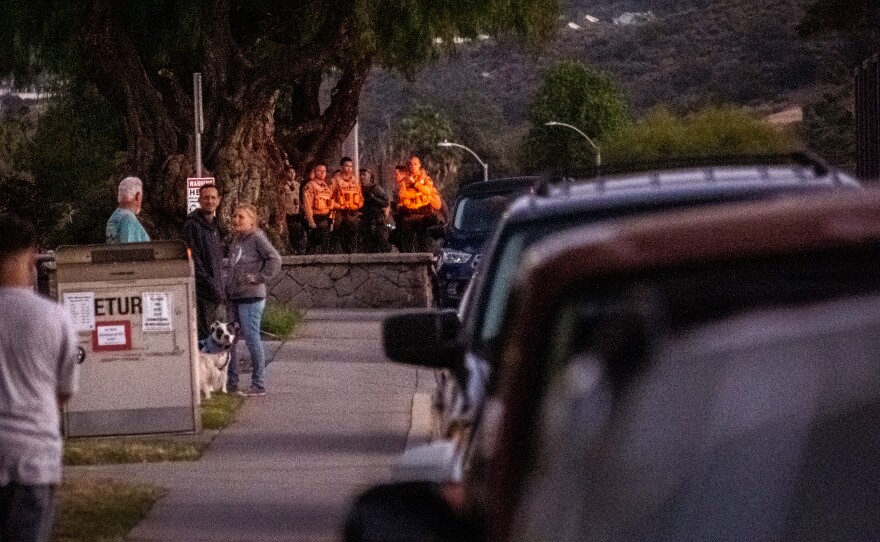 Sheriff's deputies observe anti hate crime protesters in Lakeside from a distance, April 23, 2022.