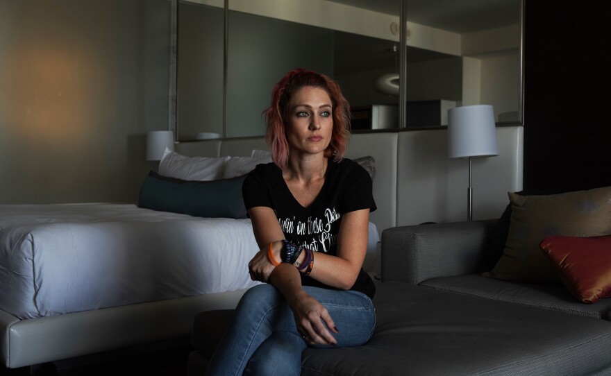 Survivor Brittany Bassett-Quintero sits in her hotel room overlooking the Las Vegas Strip on Sept. 30, 2018. Her shrapnel wounds have healed, but the emotional trauma has created aftershocks that seep into most corners of her life.