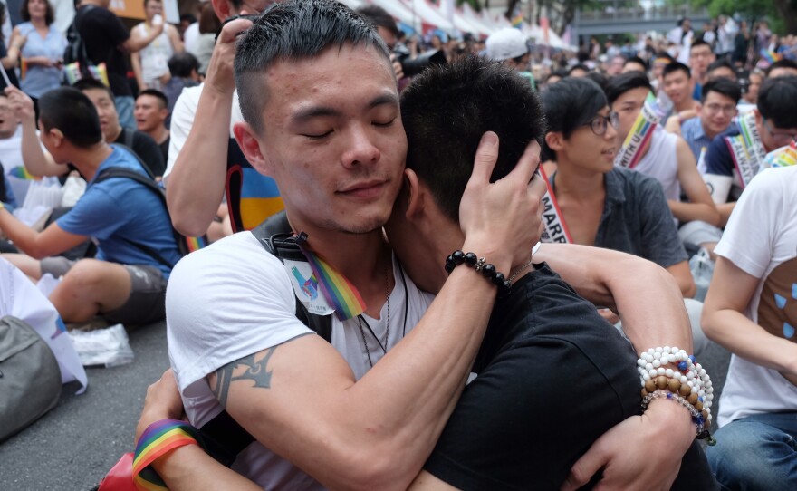 Same-sex marriage supporters hug outside Taiwan's legislature in Taipei on Wednesday after a landmark decision was announced that paves the way for the island to become the first place in Asia to legalize gay marriage.