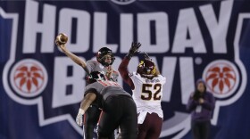 Texas Tech quarterback Davis Webb, left, throws a pass under pressure from Arizona State linebacker Carl Bradford, right, in the second half during the Holiday Bowl NCAA college football game in San Diego, Dec. 30, 2013.
