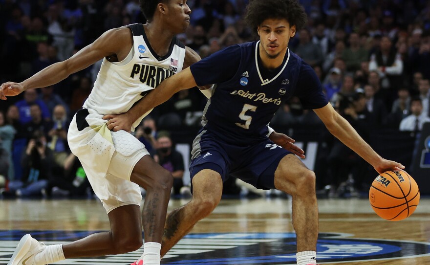 Daryl Banks III (right) of the St. Peter's Peacocks protects the ball from Eric Hunter of the Purdue Boilermakers in the second half of the game in the Sweet Sixteen round of the 2022 NCAA Men's Basketball Tournament at Wells Fargo Center on March 25.