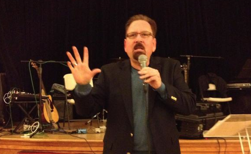 Reverend Jerry Troyer, minister at the Joyful Living Spiritual Center and the organizer of the LGBTQ Spiritual Summit, speaks to a group.