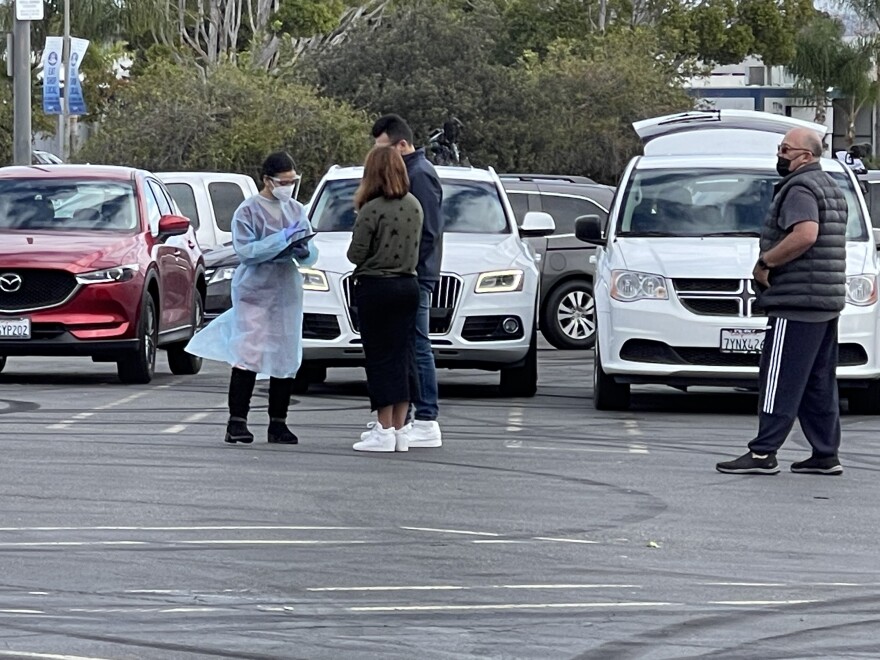 People check-in at a new COVID-19 testing site at Zion Market on Clairemont Mesa Boulevard in San Diego, Calif. Jan. 17, 2022.