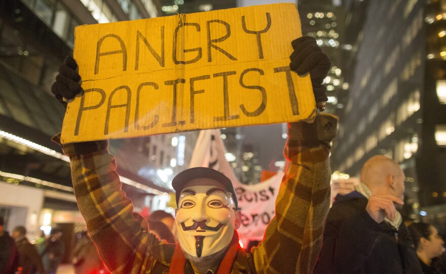 Protesters march through Midtown Manhattan on Tuesday, a day after New York City's mayor called for a pause in the demonstrations.