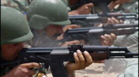 Iraqi police cadets train at a firing range in a training base in the Iraqi town of Hilla, central Iraq, on July 9, 2007.