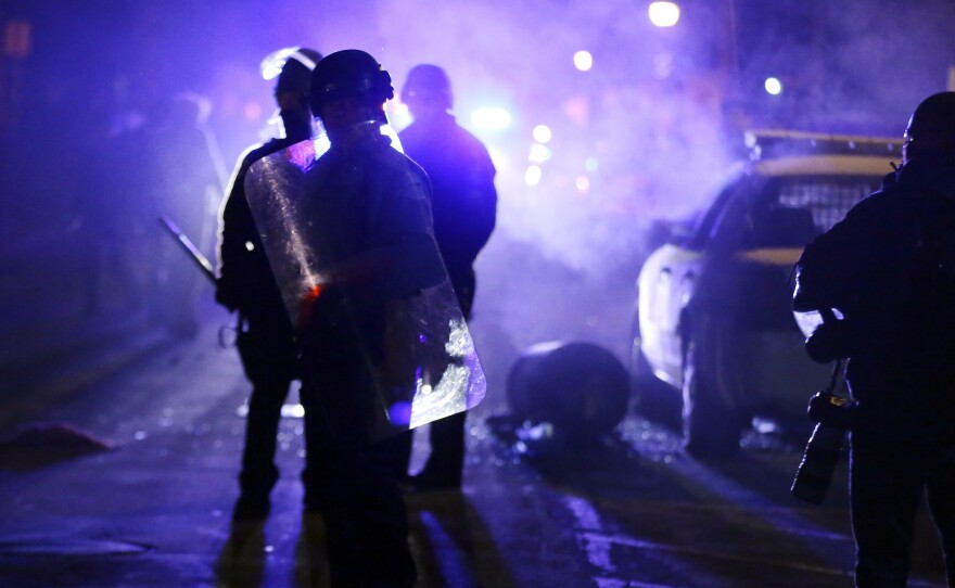 Police officers in Ferguson, Mo., during a protest in 2014. Advocates want the Justice Department to step up its oversight of law enforcement in the incoming administration.