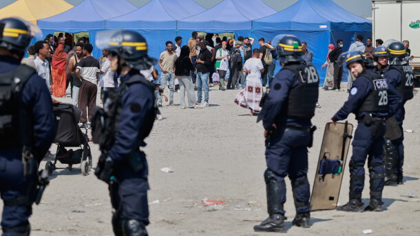 Police conduct a search operation at a makeshift camp of migrants who want to cross the English Channel to Britain near Dunkirk, northern France, Wednesday, May 27, 2026.