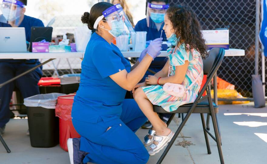 A child being tested for COVID-19 during an ACTAvando Contra COVID event at the Madera Flea Market on June 13, 2021. Visitors could get tested and sign up for vaccines while musicians played.