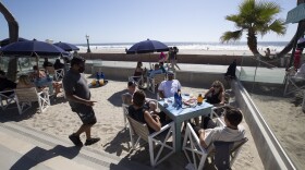 People sit at tables at the Beach House Grill Thursday, May 21, 2020, in San Diego. 

