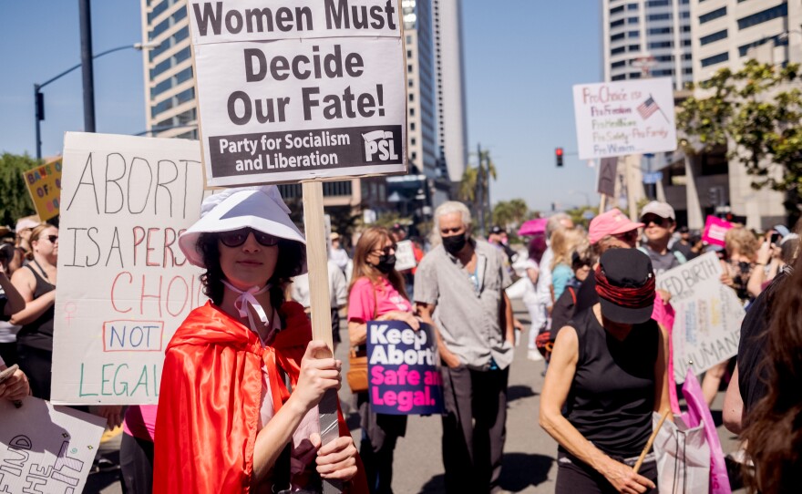 Many of the protesters at the "Bans of Our Bodies" protest and rally in downtown San Diego were not only carrying signs but also dressed as characters from the dystopian science fiction television series The Handmaid's Tale, May 14, 2022.