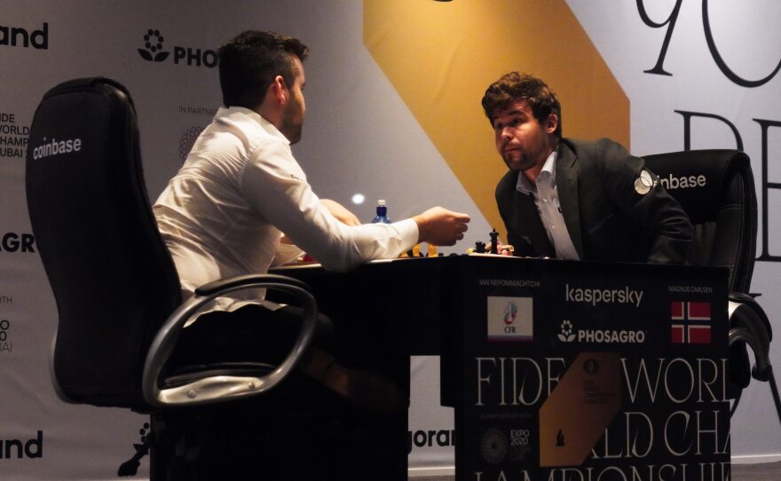 Ian Nepomniachtchi of Russia (left) and Magnus Carlsen of Norway talk after Carlsen won the FIDE World Championship in 2021. FIDE has banned competitions in Russia and Belarus in response to Russia's invasion of Ukraine.