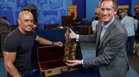 Appraiser David Bonsey (right) with a Boston guest and his 1950 Selmer alto saxophone.