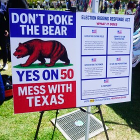 Supporters of a plan to redraw California's congressional districts ahead of the 2026 general election display a sign outside of the San Diego County administration building on Sep. 1, 2025 in San Diego, Calif.