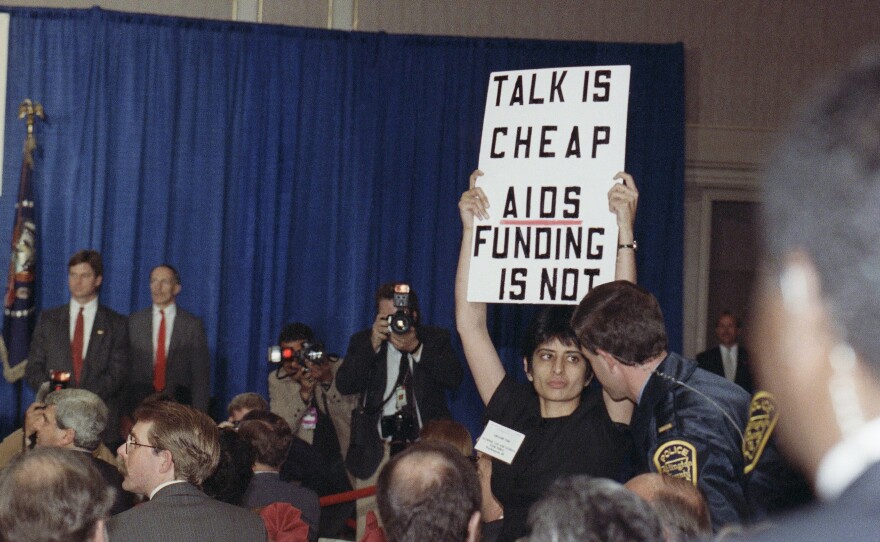 Urvashi Vaid, then-executive director of the National Gay and Lesbian Task Force, protests at then-President George H.W. Bush's address on AIDS in March 1990 in Arlington, Virginia. The pioneering LGBTQ activist and attorney died last week at age 63.