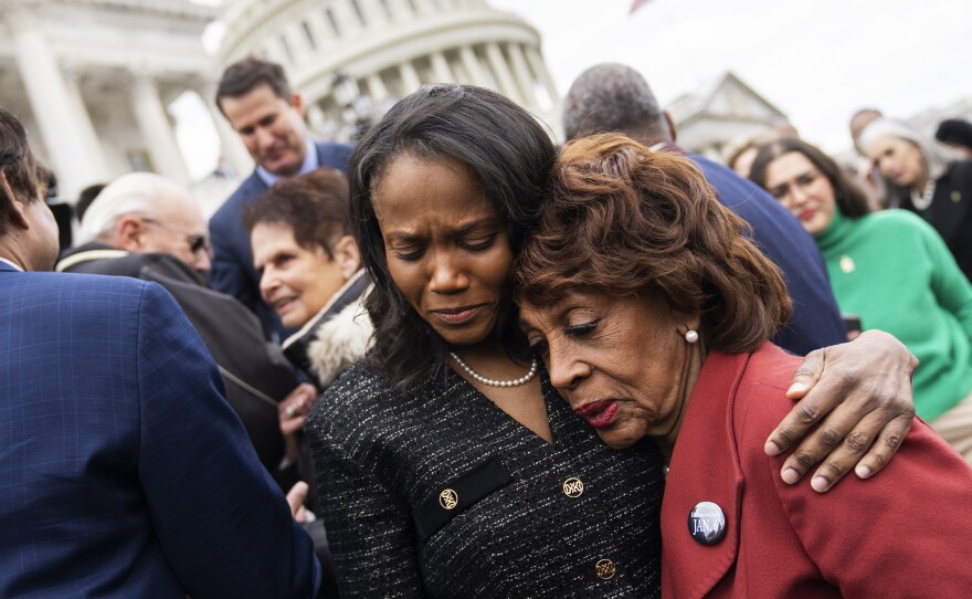 Dr. Serena Liebengood, center, the wife of the late U.S. Capitol Police Officer Howard Liebengood, and Rep. Maxine Waters, D-Calif., embrace during a ceremony to mark second anniversary of January 6th riot at the U.S. Capitol on Friday. Officer Liebengood will receive the Presidential Citizens Medal posthumously later Friday.