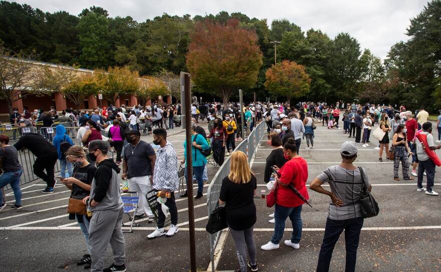 Hundreds of people wait in line for early voting earlier this week in Marietta, Ga. Eager voters have waited six hours or more in the former Republican stronghold of Cobb County, and lines have wrapped around buildings in solidly Democratic DeKalb County.