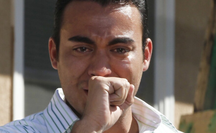 Talking about his father, a wounded veteran, Andy Cavalier is overcome with emotion while asking President Obama a question during a backyard discussion in Albuquerque, N.M., on Sept. 28.