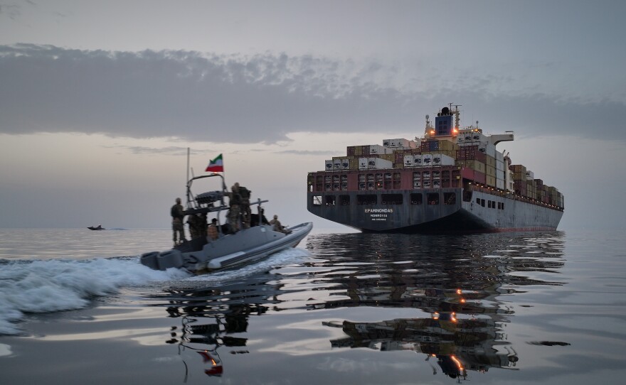 A Revolutionary Guard Navy (IRGC) speedboat approaches the cargo ship Epaminondas during what state media described as the seizure of one of two vessels accused of violations in the Strait of Hormuz, April 21, 2026.