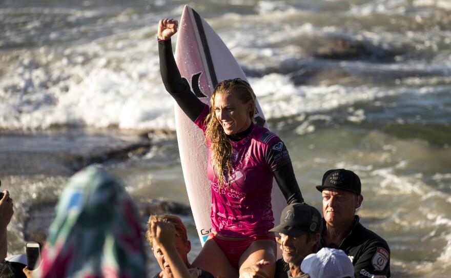 U.S. surfer Lakey Peterson is carried up the beach after claiming victory in a World Surf League event in Australia in March. The league says it will start paying the same prize money to men and women.