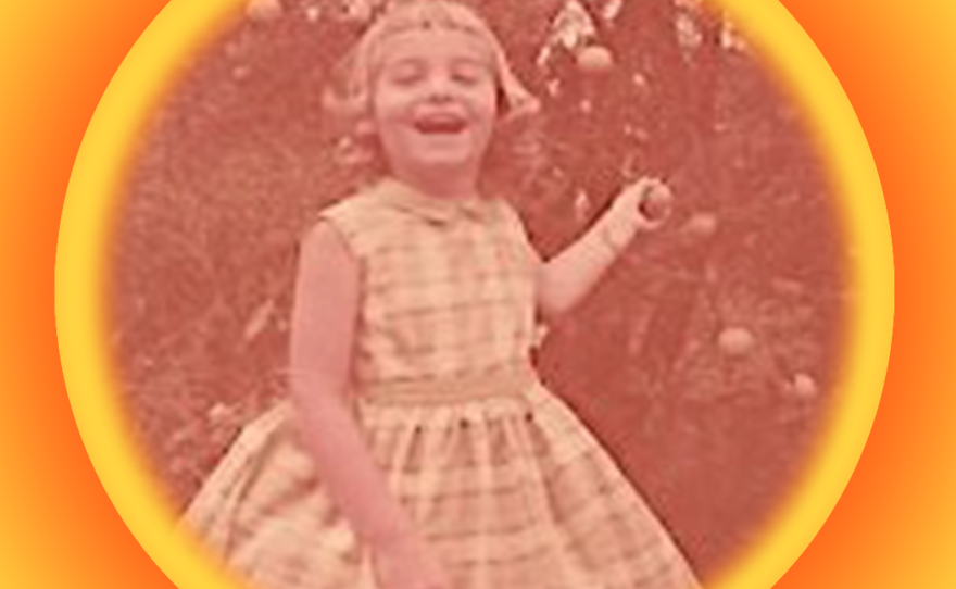 Portrait of Donna Frye as a child holding a shrub branch