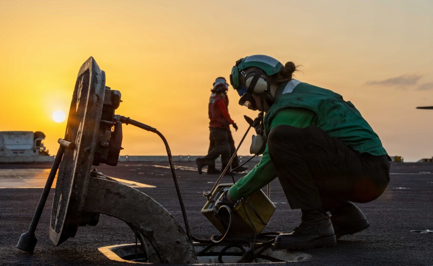 A sailor conducts maintenance on catapult communications on the flight deck of the San Diego-based aircraft carrier USS Abraham Lincoln during Operation Epic Fury, April 2, 2026.
